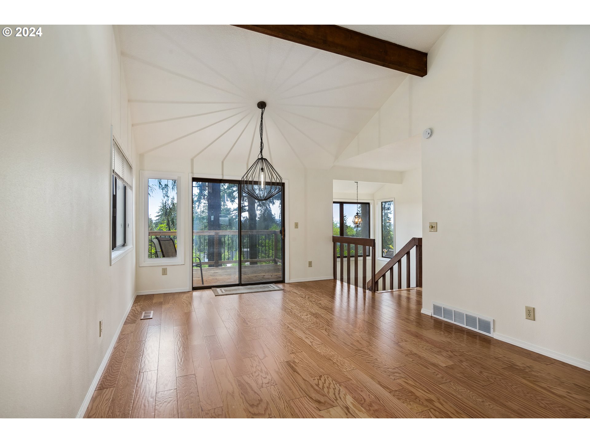 4243 Southwest Stephenson Street Portland, OR 97219 - Photo 14 of 48 a hallway with wooden floor table and chairs