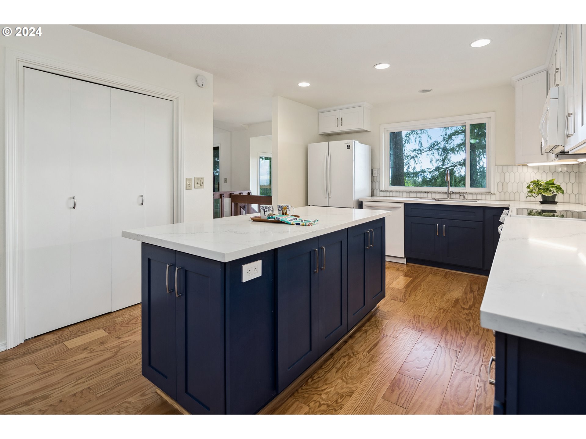 4243 Southwest Stephenson Street Portland, OR 97219 - Photo 17 of 48 a kitchen with stainless steel appliances granite countertop wooden cabinets a stove a sink and a refrigerator