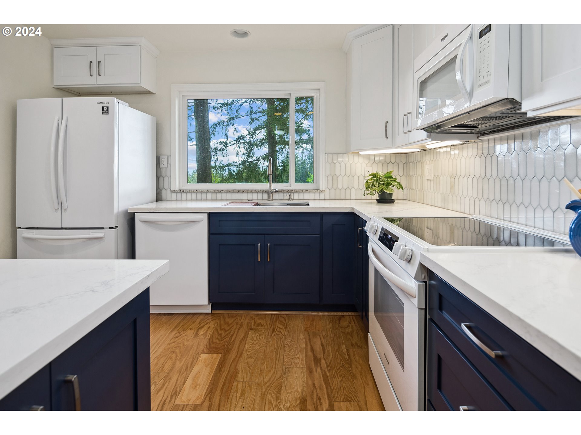 4243 Southwest Stephenson Street Portland, OR 97219 - Photo 18 of 48 a kitchen with a sink refrigerator and cabinets