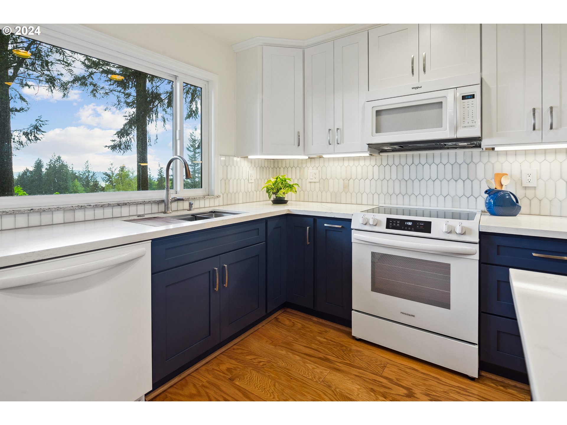 4243 Southwest Stephenson Street Portland, OR 97219 - Photo 19 of 48 a kitchen with stainless steel appliances granite countertop a stove a sink and a microwave