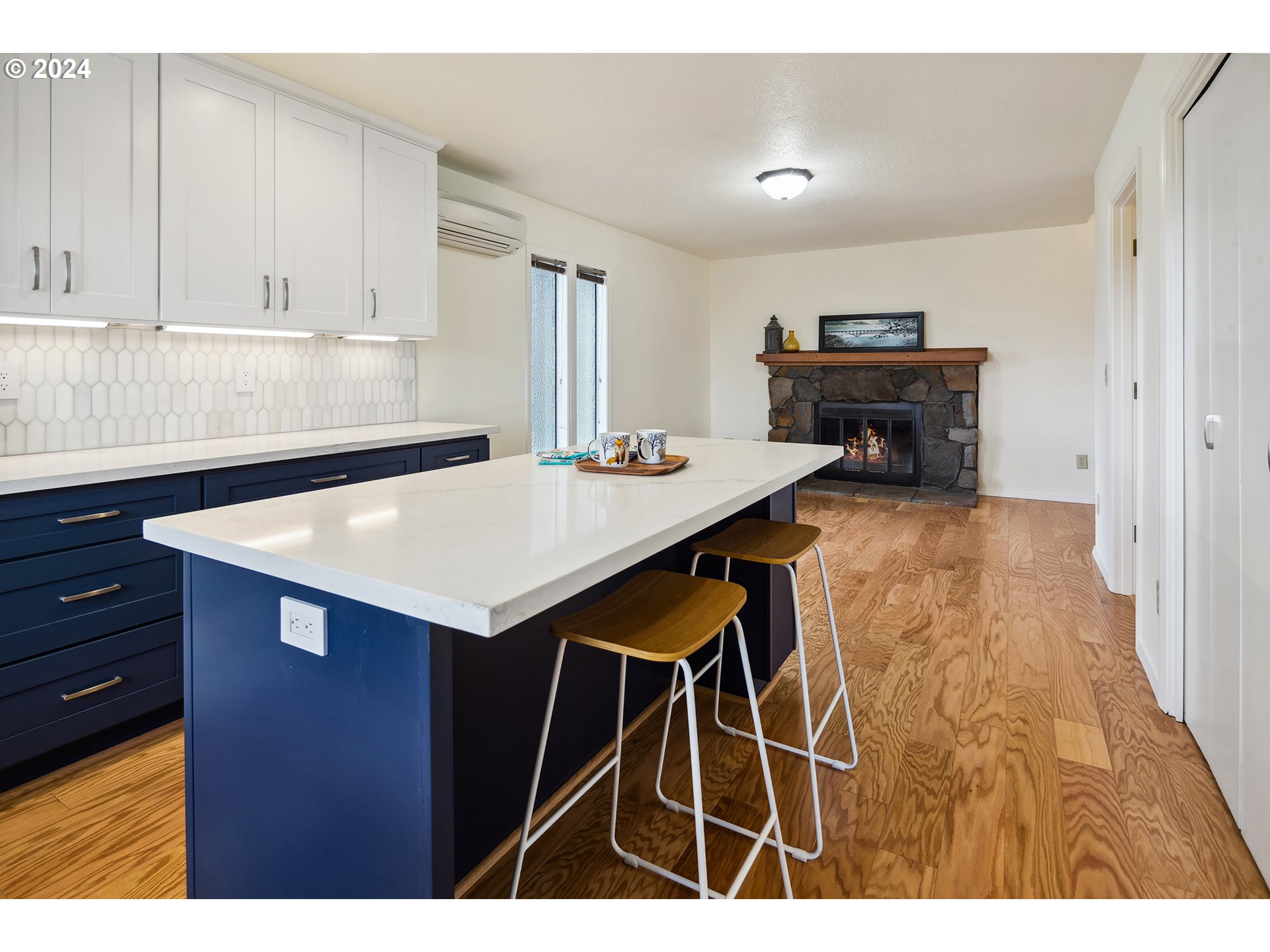 4243 Southwest Stephenson Street Portland, OR 97219 - Photo 20 of 48 a kitchen with kitchen island a sink table and chairs