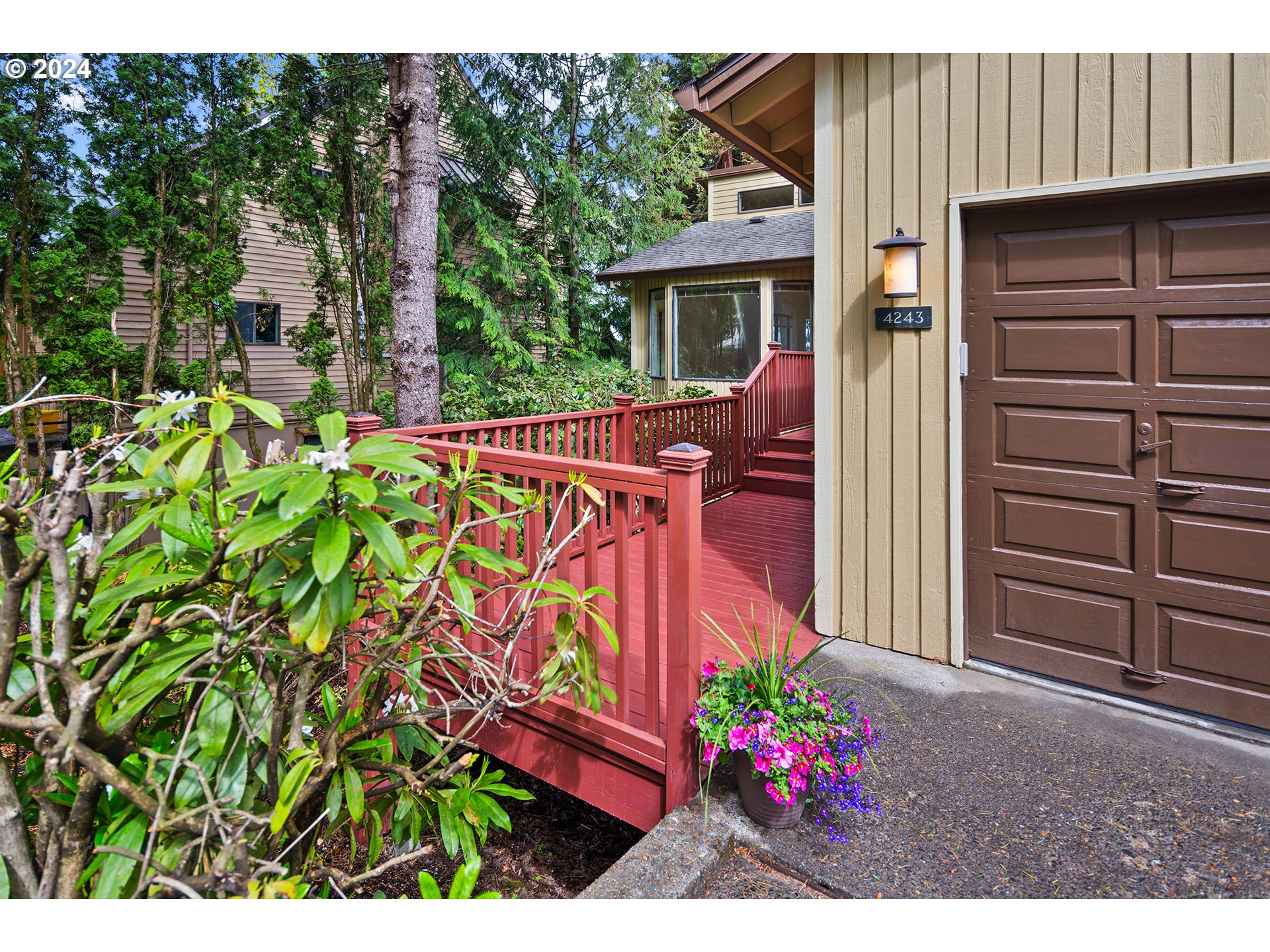 4243 Southwest Stephenson Street Portland, OR 97219 - Photo 2 of 48 a view of a house with a flower garden