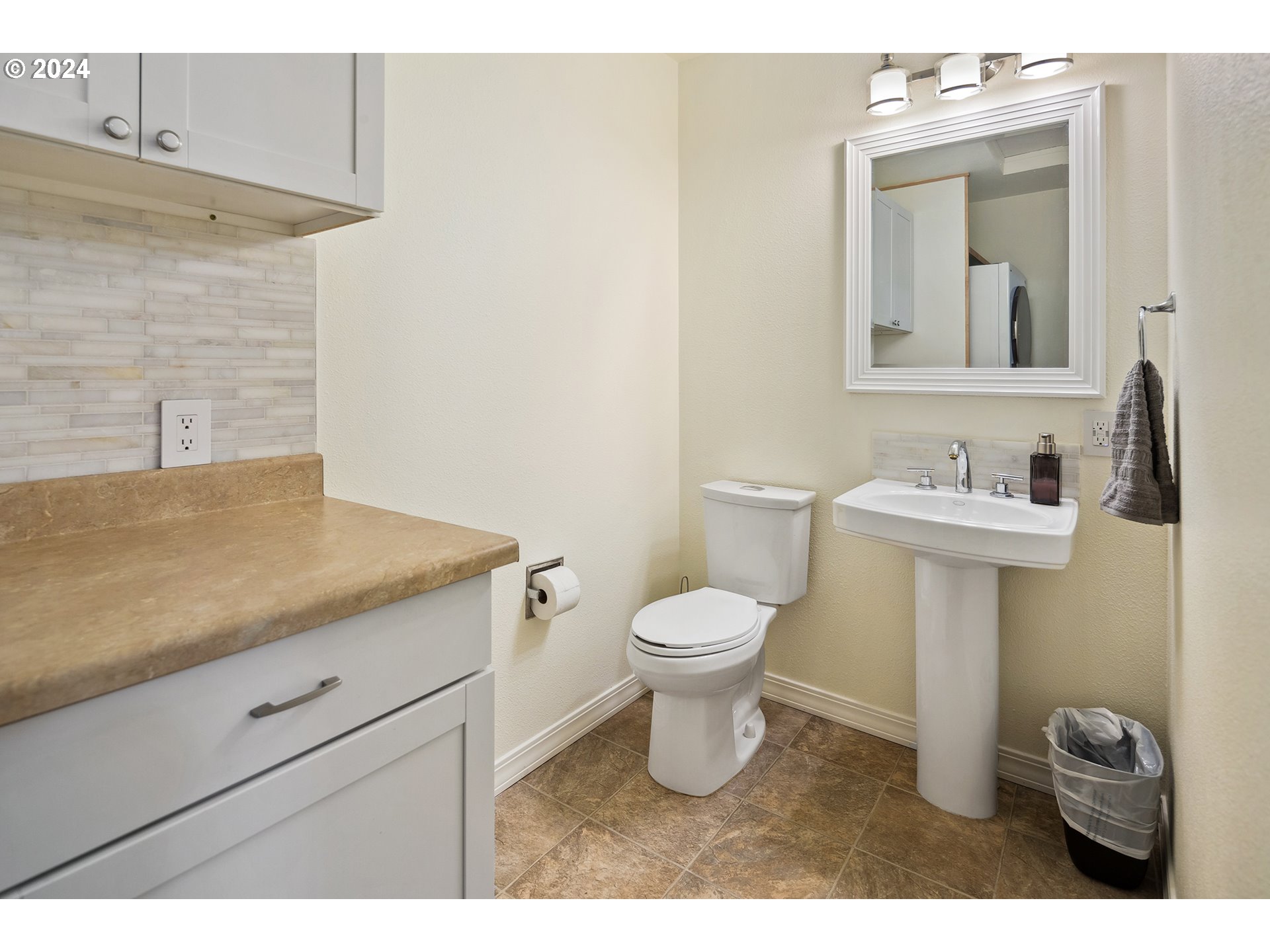 4243 Southwest Stephenson Street Portland, OR 97219 - Photo 24 of 48 a bathroom with a toilet sink and mirror