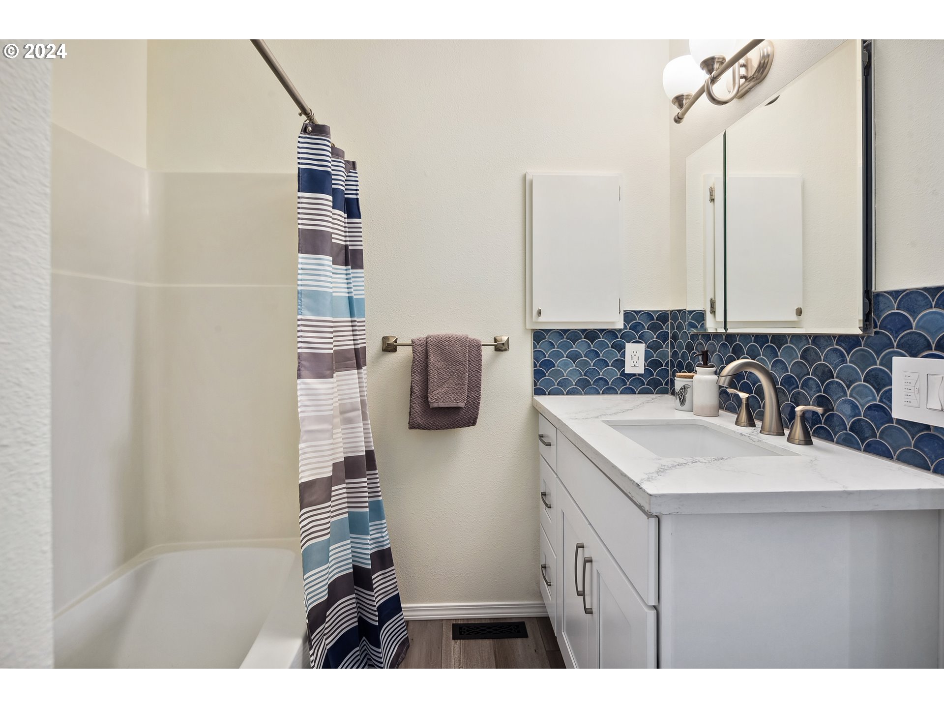 4243 Southwest Stephenson Street Portland, OR 97219 - Photo 30 of 48 a bathroom with a sink and mirror