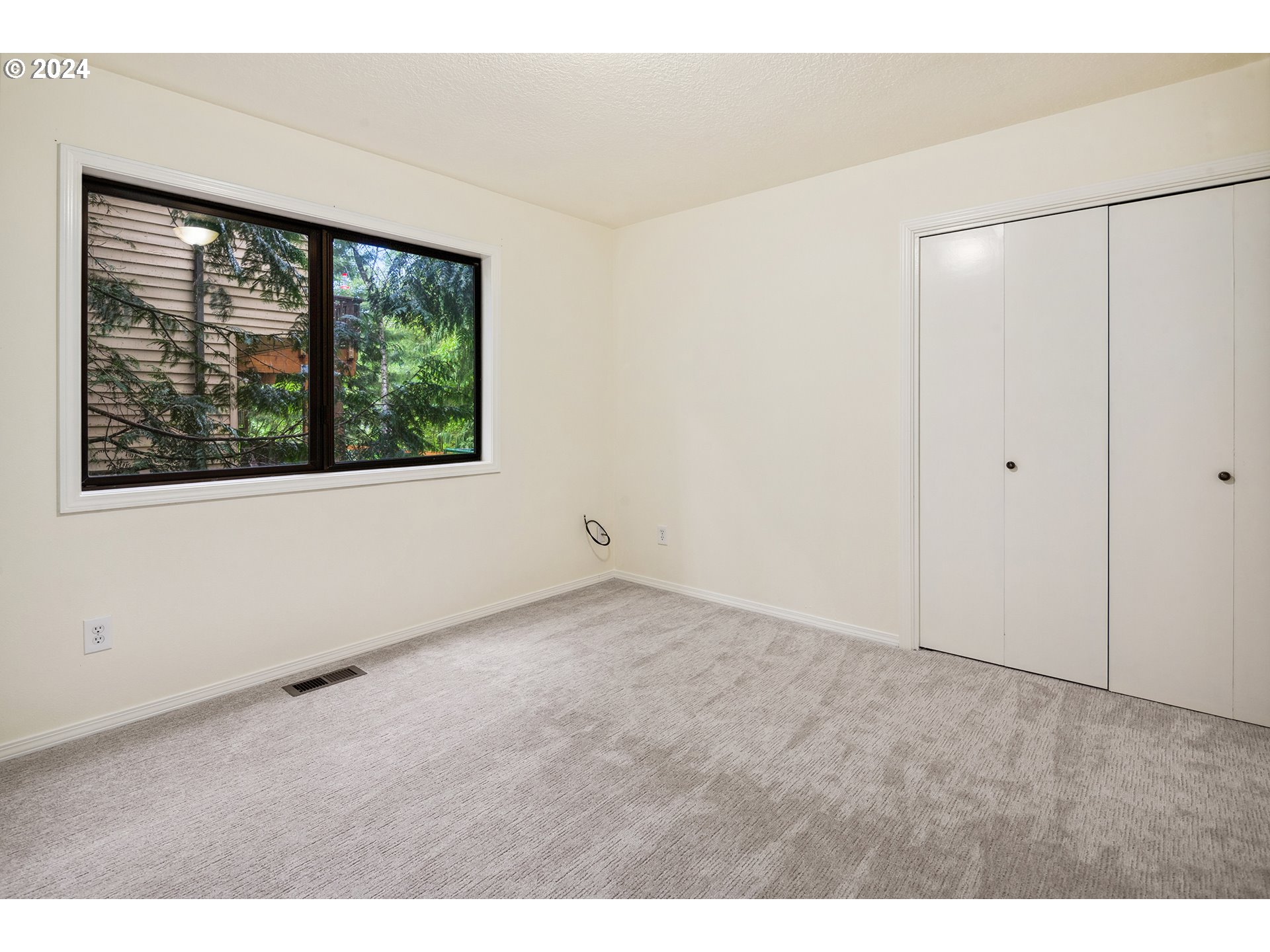4243 Southwest Stephenson Street Portland, OR 97219 - Photo 32 of 48 a view of an empty room with a window