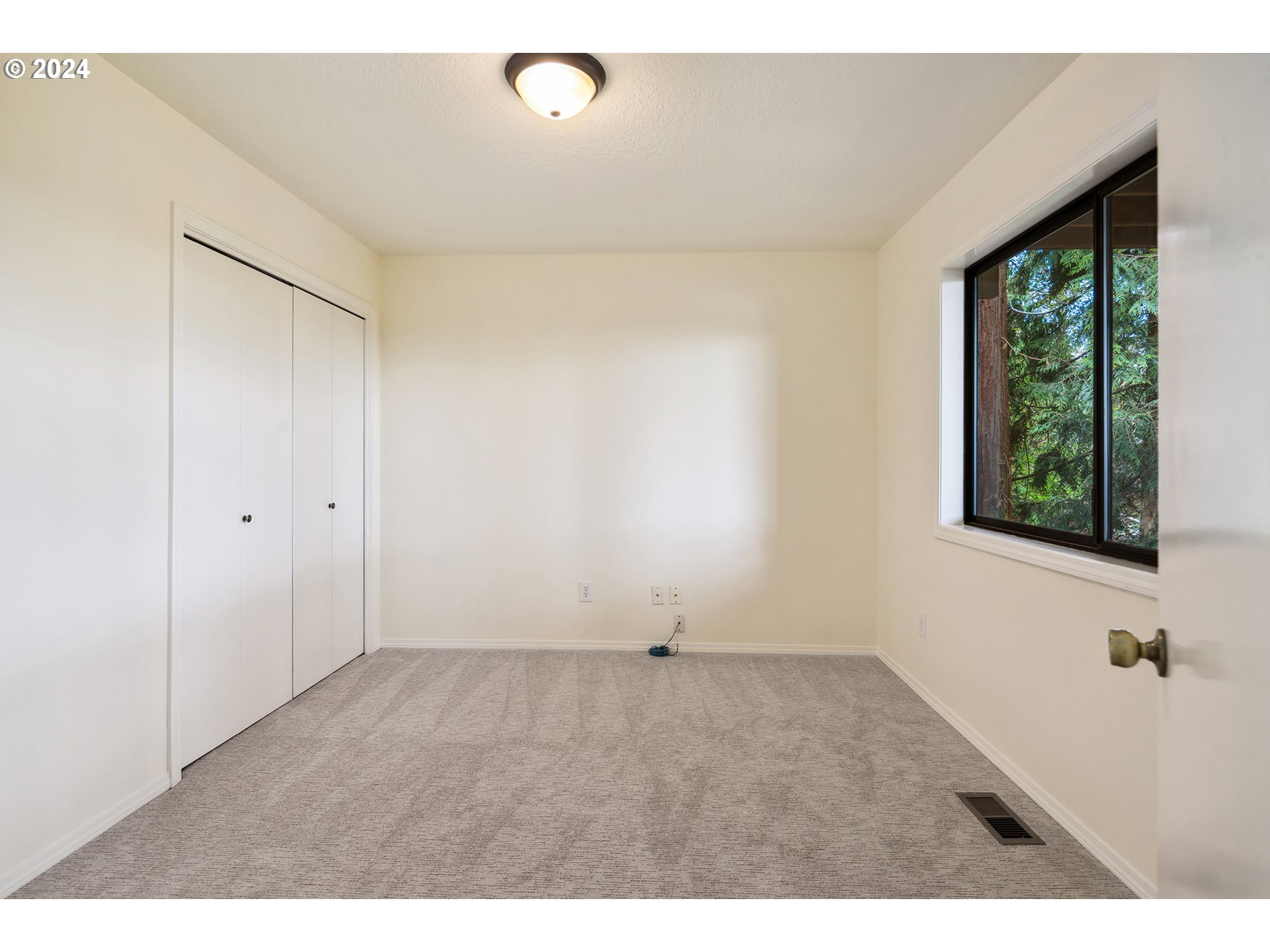 4243 Southwest Stephenson Street Portland, OR 97219 - Photo 35 of 48 a view of an empty room with a window