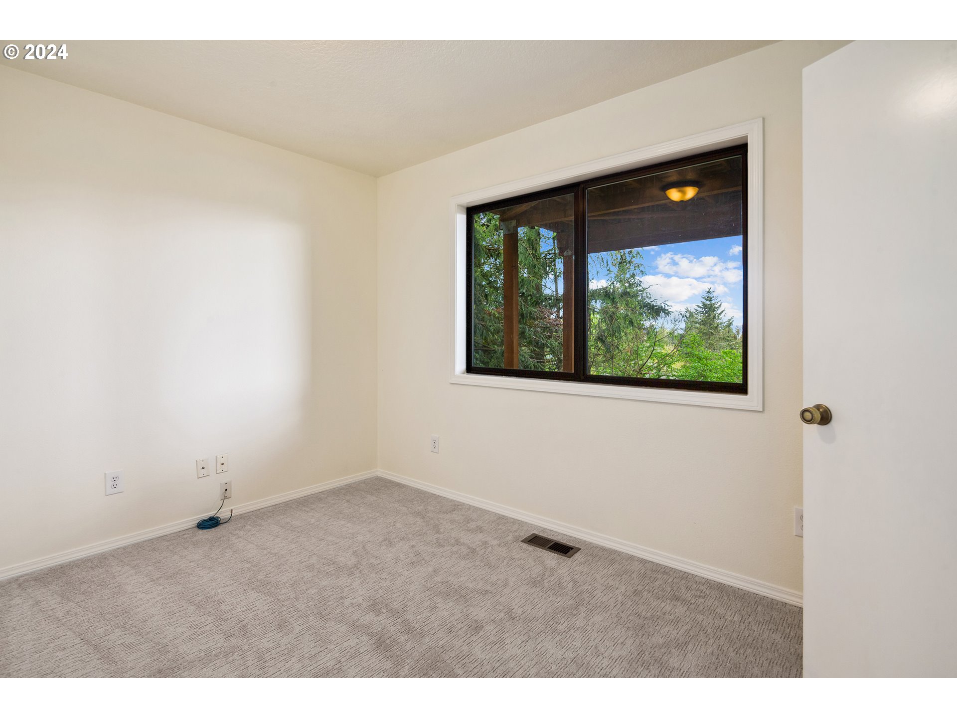 4243 Southwest Stephenson Street Portland, OR 97219 - Photo 36 of 48 a view of an empty room with a window