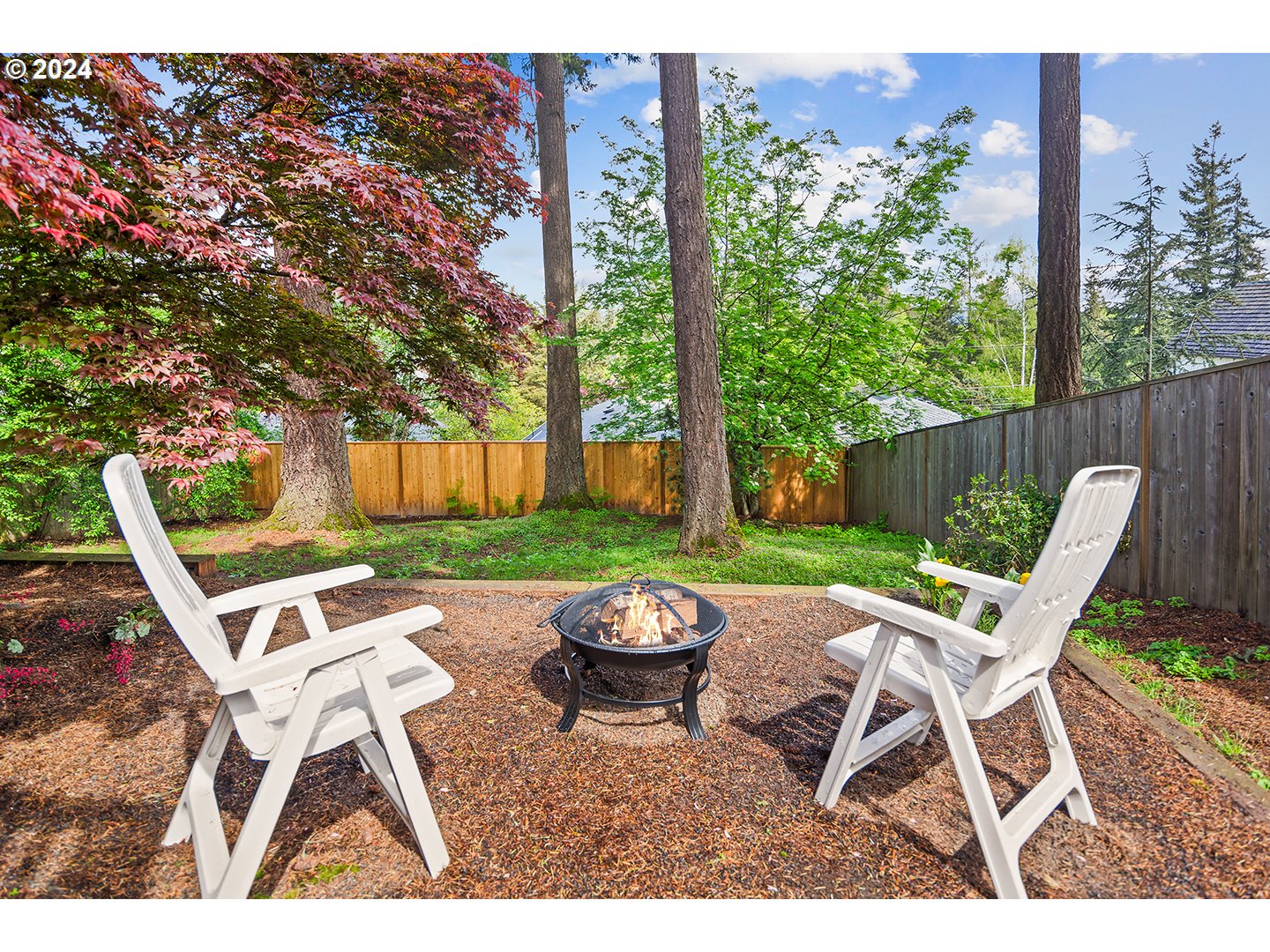 4243 Southwest Stephenson Street Portland, OR 97219 - Photo 43 of 48 a view of a chair and table in backyard of the house
