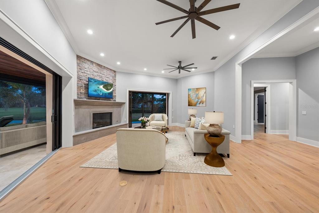 19 Hibiscus Road Belleair, FL 33756 - Photo 16 of 44 a living room with furniture a fireplace and a floor to ceiling window