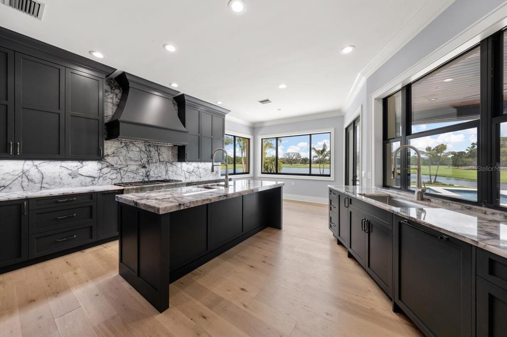 19 Hibiscus Road Belleair, FL 33756 - Photo 18 of 44 a large kitchen with stainless steel appliances kitchen island granite countertop a sink and cabinets