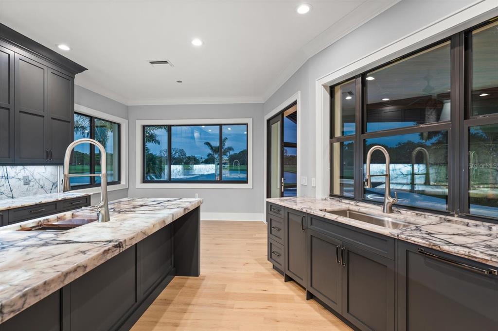 19 Hibiscus Road Belleair, FL 33756 - Photo 21 of 44 a large kitchen with granite countertop a sink and a large window