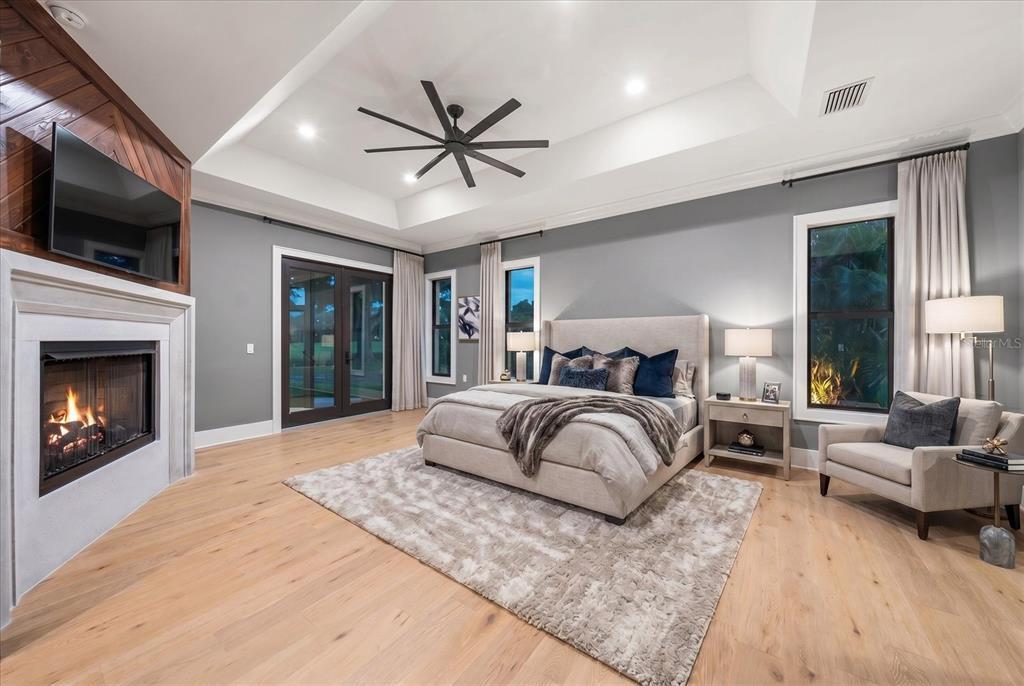 19 Hibiscus Road Belleair, FL 33756 - Photo 24 of 44 a bedroom with a large bed and a fireplace