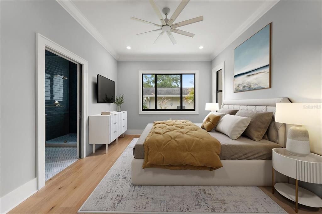 19 Hibiscus Road Belleair, FL 33756 - Photo 29 of 44 a spacious bedroom with a bed and a flat screen tv