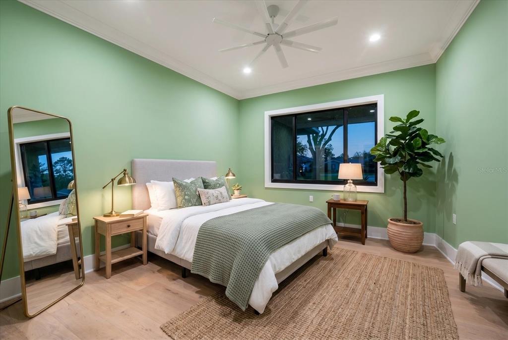 19 Hibiscus Road Belleair, FL 33756 - Photo 31 of 44 a bedroom with a large bed and a potted plant