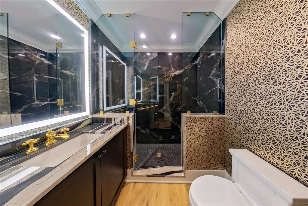 19 Hibiscus Road Belleair, FL 33756 - Photo 33 of 44 a bathroom with a sink mirror vanity and toilet