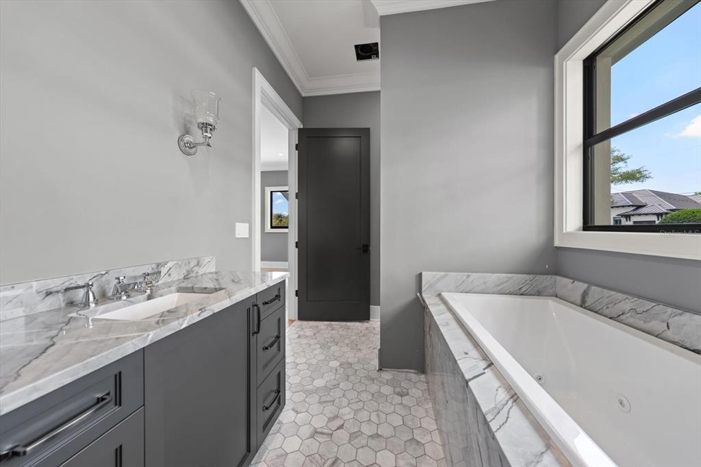 19 Hibiscus Road Belleair, FL 33756 - Photo 40 of 44 a spacious bathroom with a tub sink and mirror