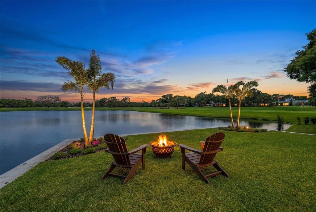 19 Hibiscus Road Belleair, FL 33756 - Photo 4 of 44 a view of a lake with a bench in a lake