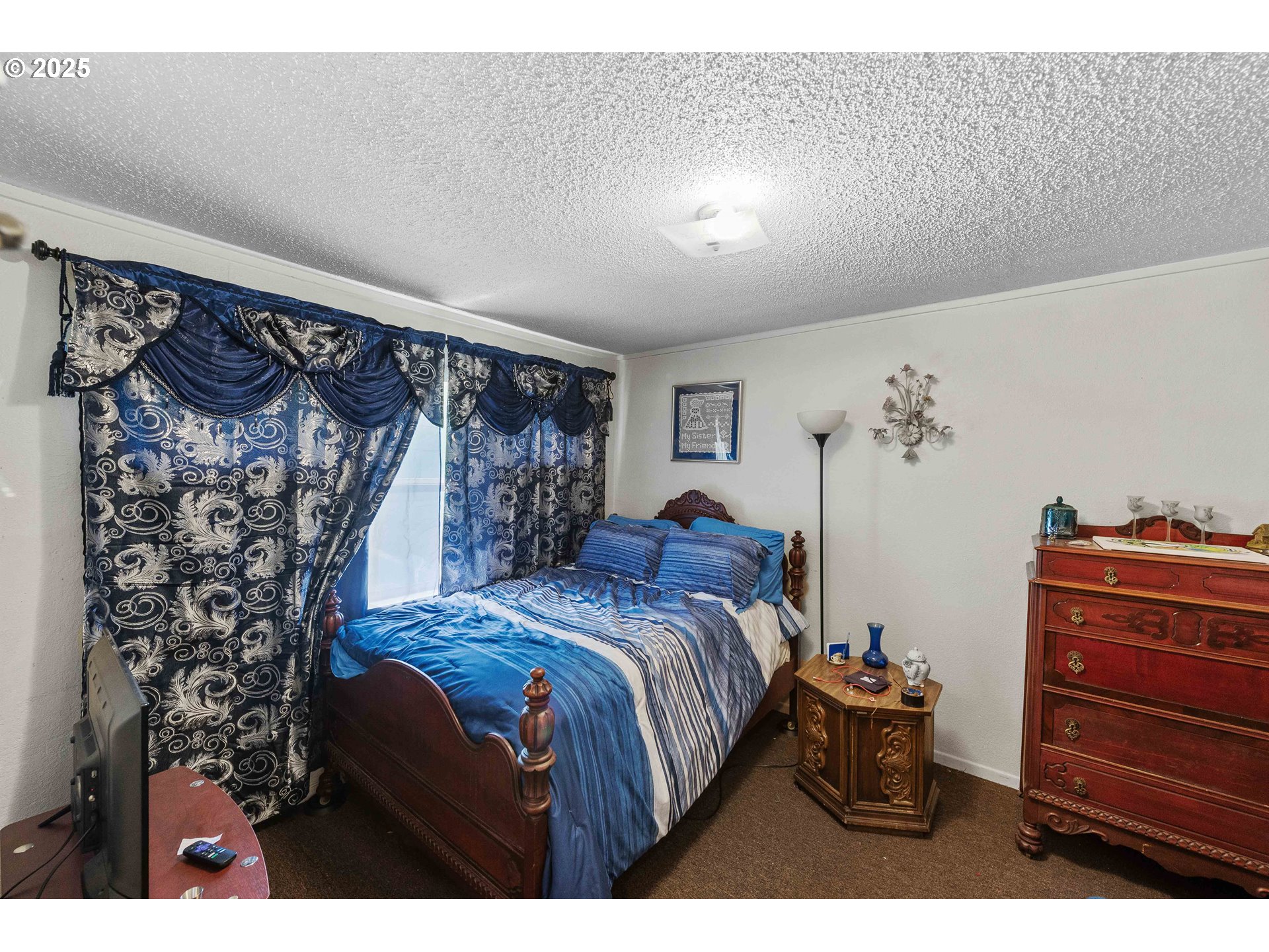 1902 Monroe Street North Bend, OR 97459 - Photo 11 of 48 a bedroom with a bed and a dresser