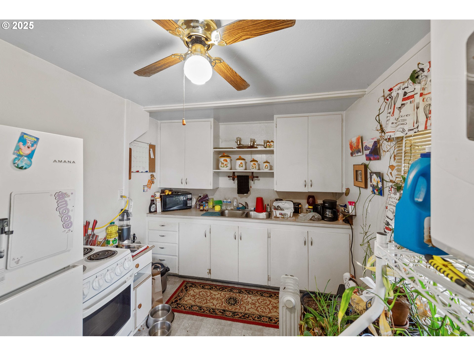 1902 Monroe Street North Bend, OR 97459 - Photo 14 of 48 a kitchen that has a lot of cabinets a sink and wooden floor