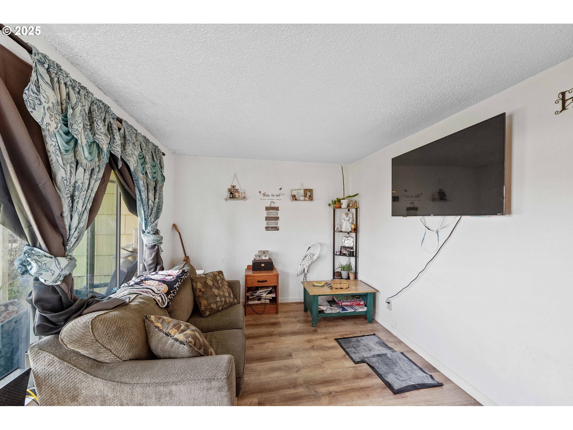 1902 Monroe Street North Bend, OR 97459 - Photo 23 of 48 a living room with furniture and a flat screen tv