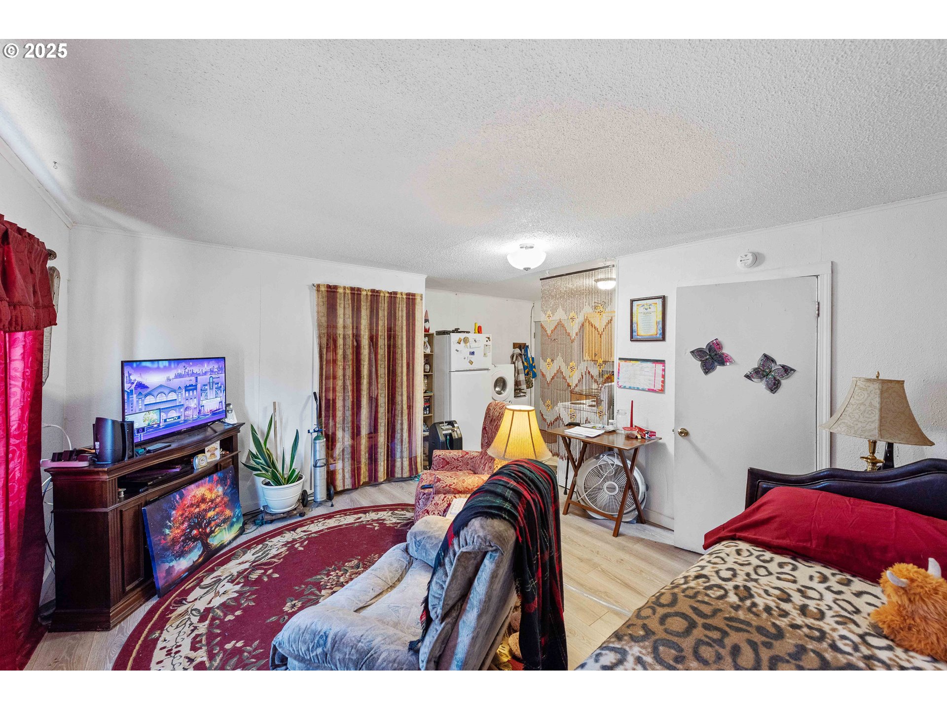 1902 Monroe Street North Bend, OR 97459 - Photo 40 of 48 a bedroom with furniture a flat screen tv and a bed