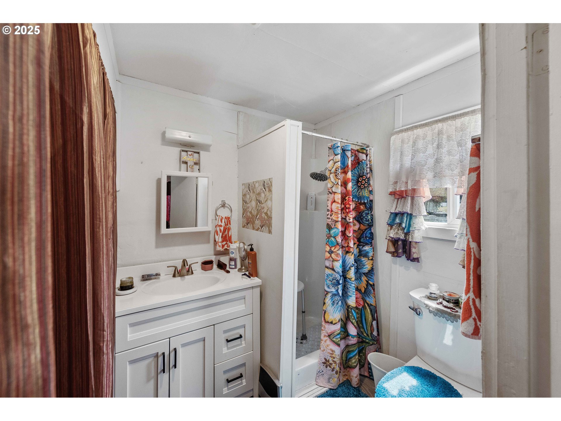 1902 Monroe Street North Bend, OR 97459 - Photo 41 of 48 a bathroom with a sink a mirror and a shower