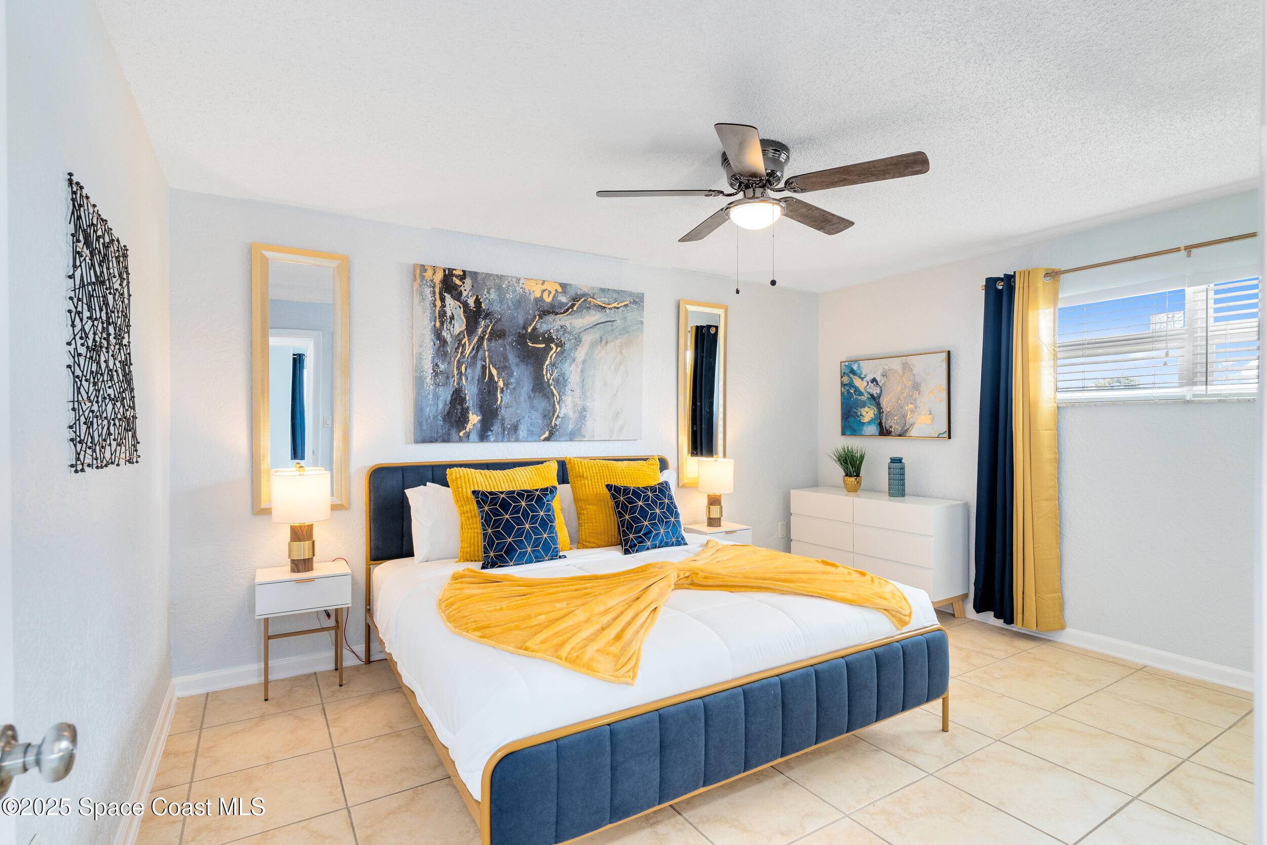 1029 Park Drive, Unit 32 Indian Harbour Beach, FL 32937 - Photo 11 of 35 a bedroom with a bed and ceiling fan