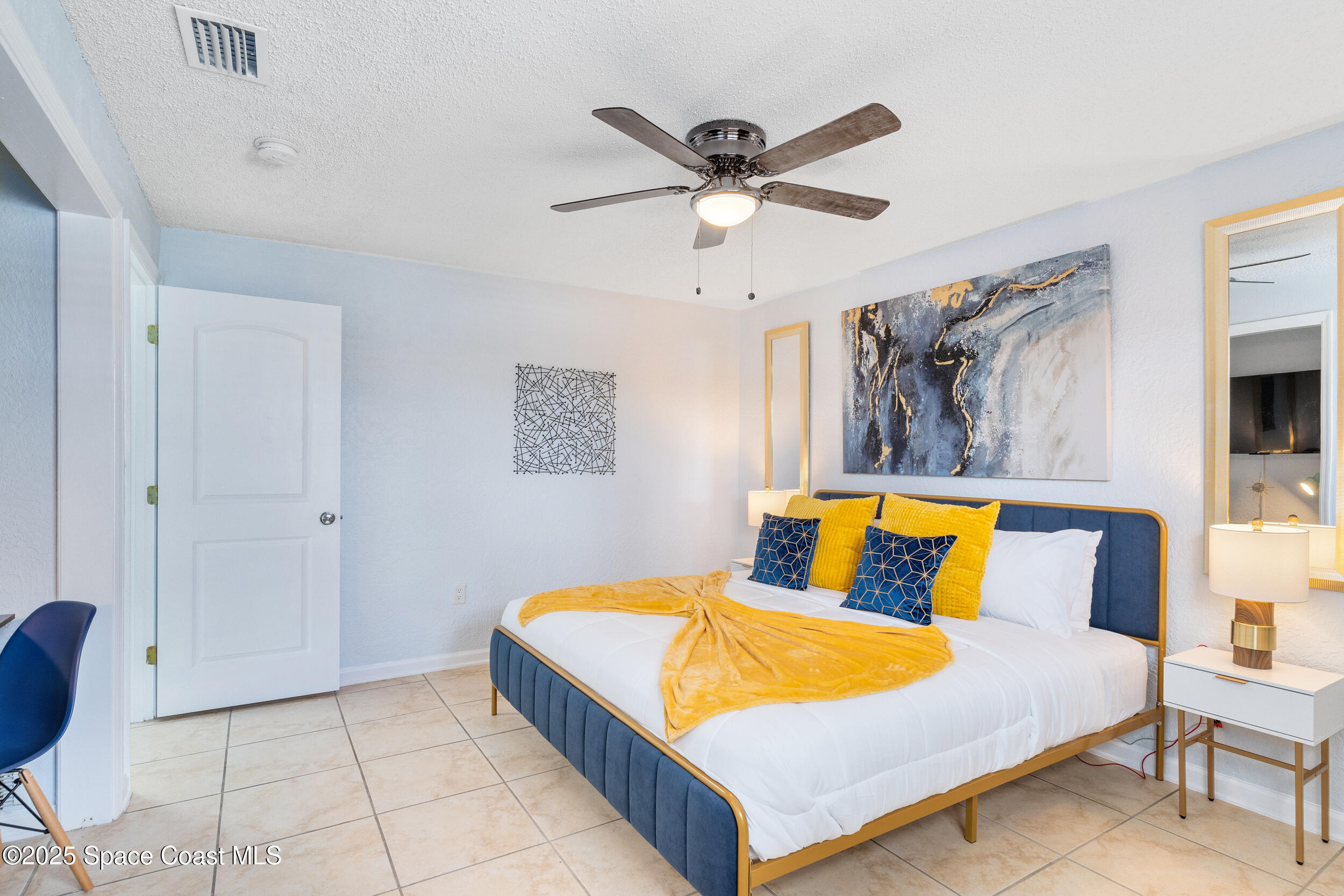 1029 Park Drive, Unit 32 Indian Harbour Beach, FL 32937 - Photo 12 of 35 a bedroom with a bed and painting on the wall