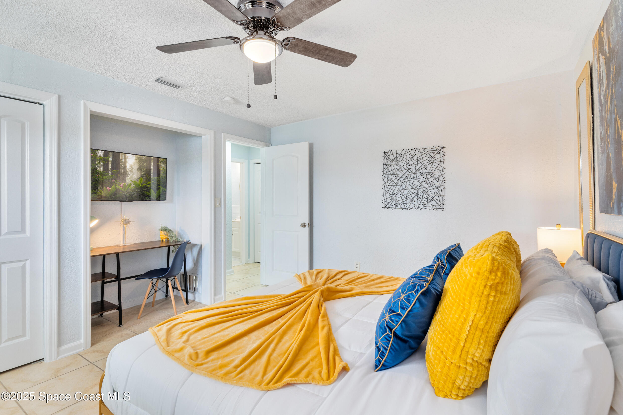 1029 Park Drive, Unit 32 Indian Harbour Beach, FL 32937 - Photo 13 of 35 a bed room with a bed and painting on the wall