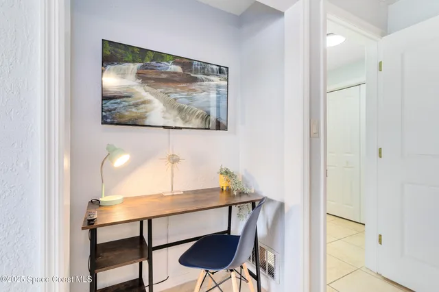 a view of a workspace with furniture