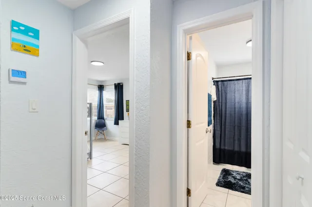 a bathroom with a sink a toilet and shower curtain