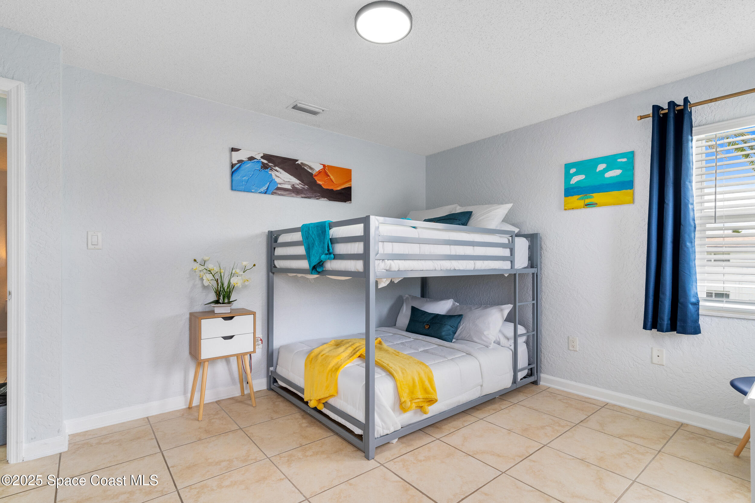 1029 Park Drive, Unit 32 Indian Harbour Beach, FL 32937 - Photo 20 of 35 a bedroom with a bed and a window