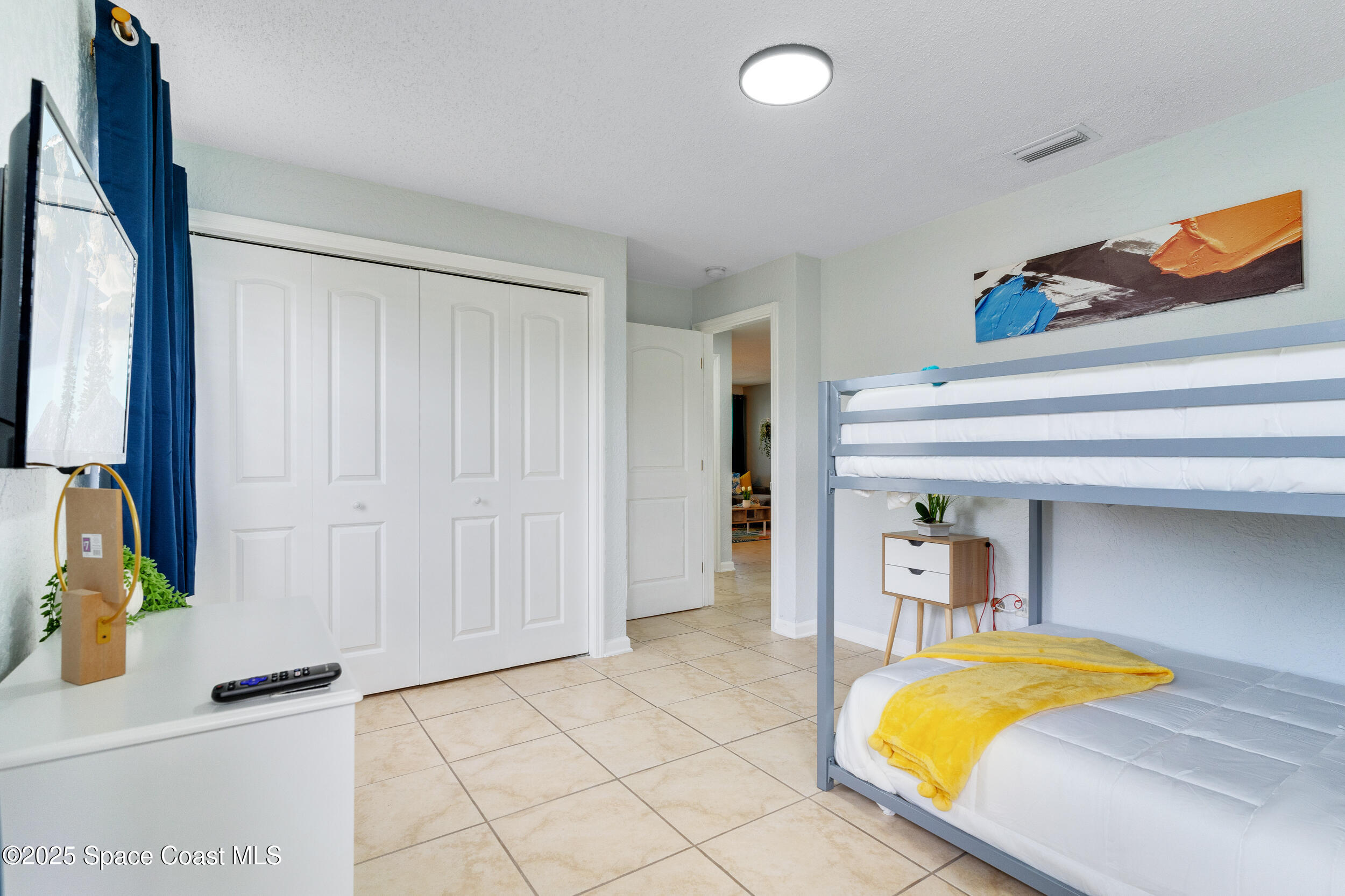 1029 Park Drive, Unit 32 Indian Harbour Beach, FL 32937 - Photo 21 of 35 a bedroom with a bed and a dresser