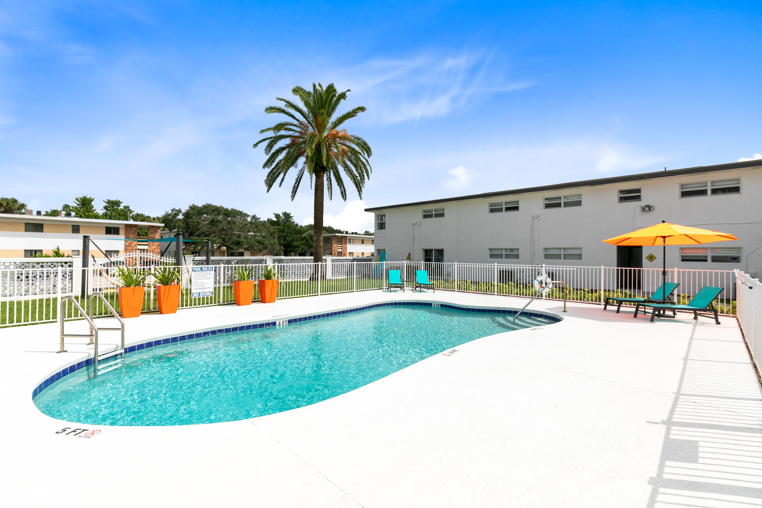 1029 Park Drive, Unit 32 Indian Harbour Beach, FL 32937 - Photo 30 of 35 an outdoor space with swimming pool and furniture