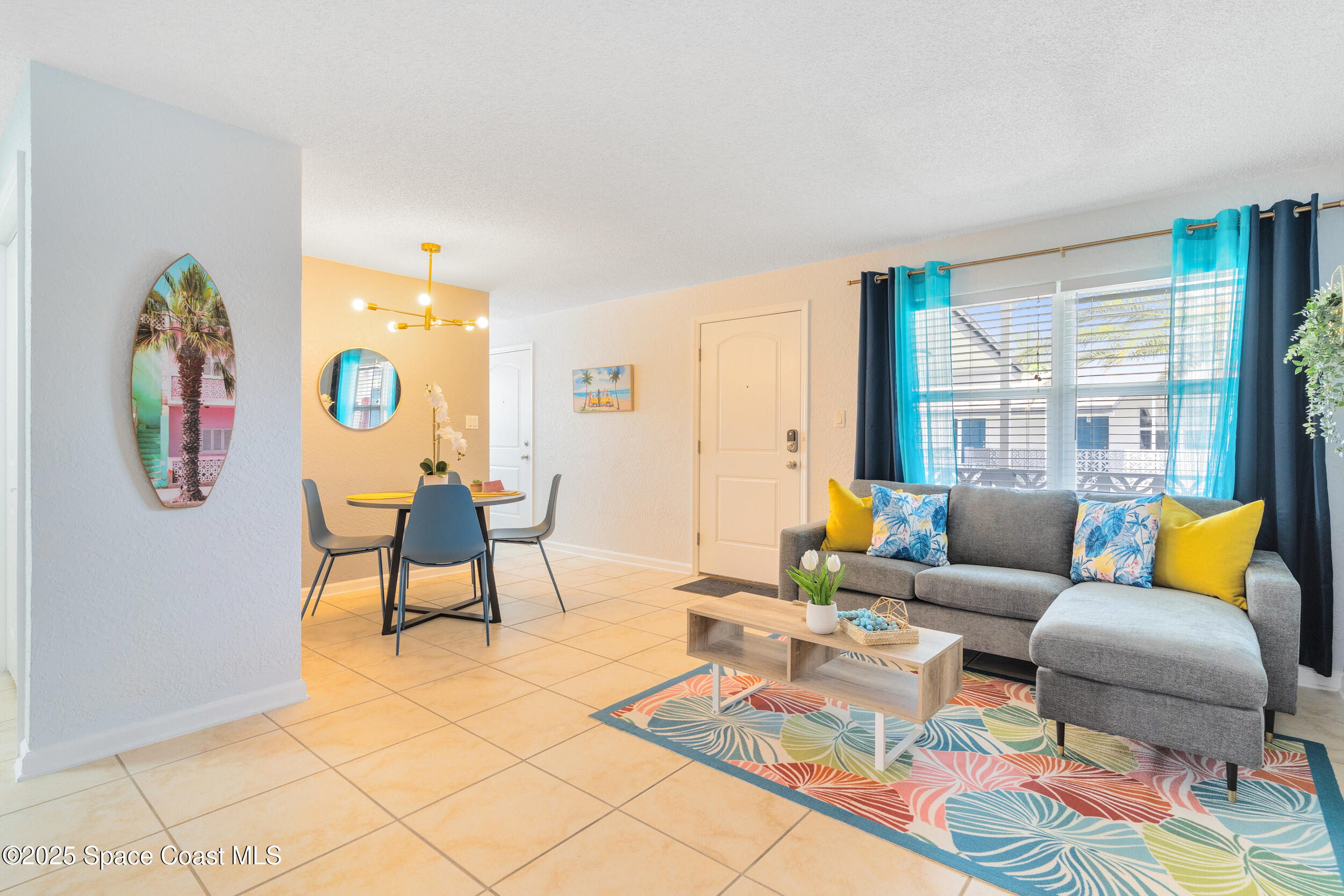 1029 Park Drive, Unit 32 Indian Harbour Beach, FL 32937 - Photo 4 of 35 a living room with furniture and a large window