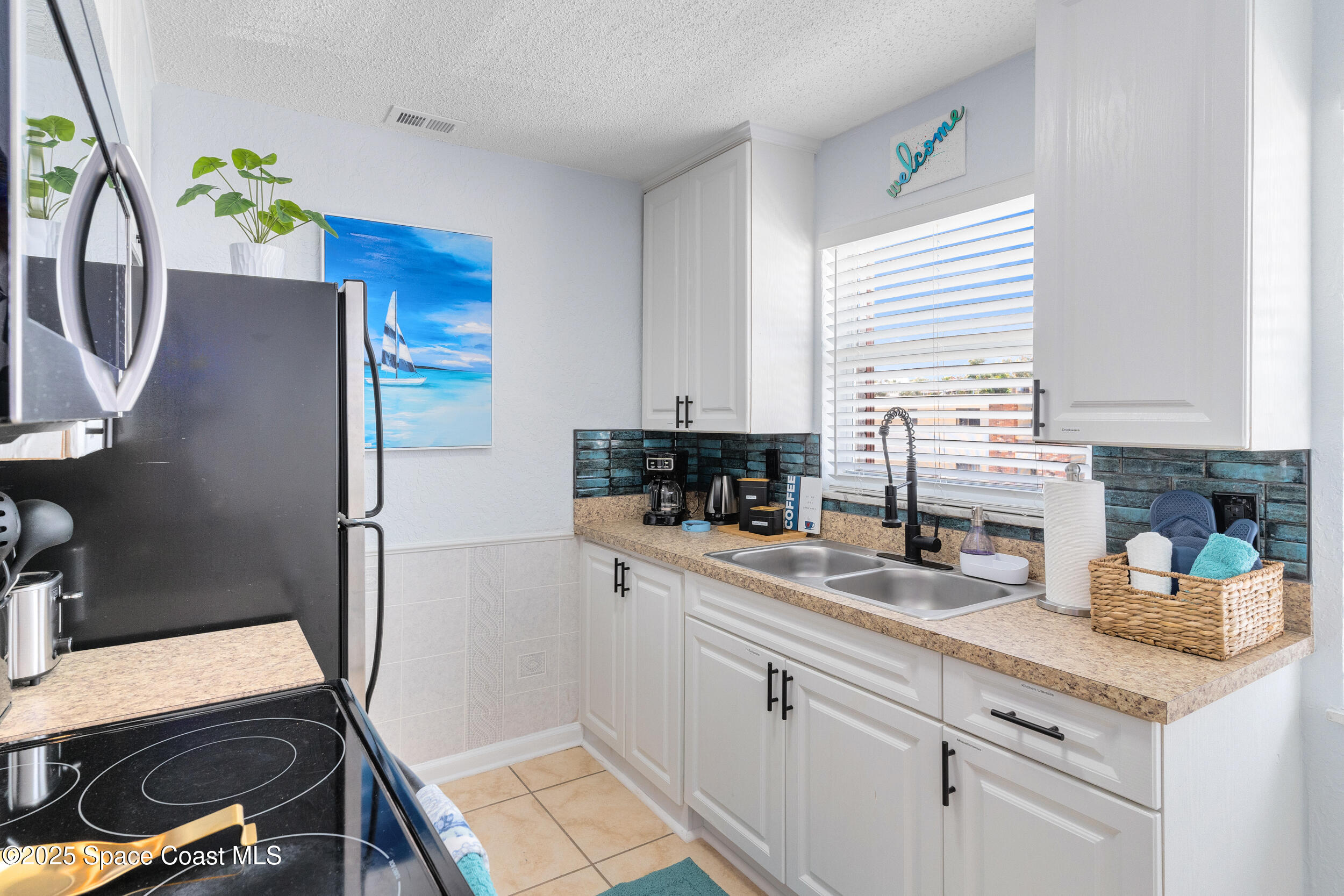 1029 Park Drive, Unit 32 Indian Harbour Beach, FL 32937 - Photo 6 of 35 a kitchen with a sink appliances and cabinets