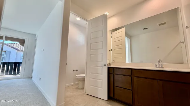 an empty room with closet and a ceiling fan