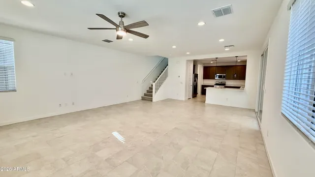 an empty room with closet and ceiling fan
