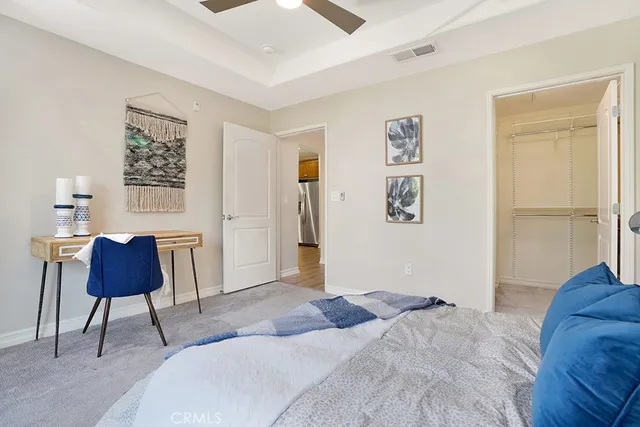 a bedroom with a bed and a chair with the walls