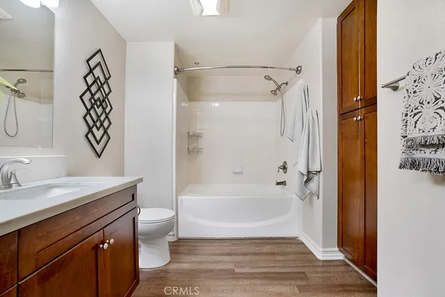a bathroom with a bathtub sink mirror vanity and toilet