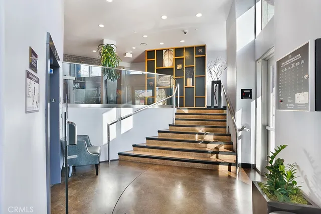 a view of entryway and hall with wooden floor