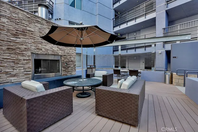 a view of a patio with couches and a potted plant on a table