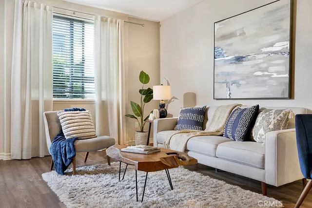 a living room with furniture and a potted plant