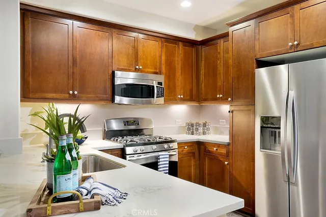 a kitchen with a refrigerator a stove and cabinets