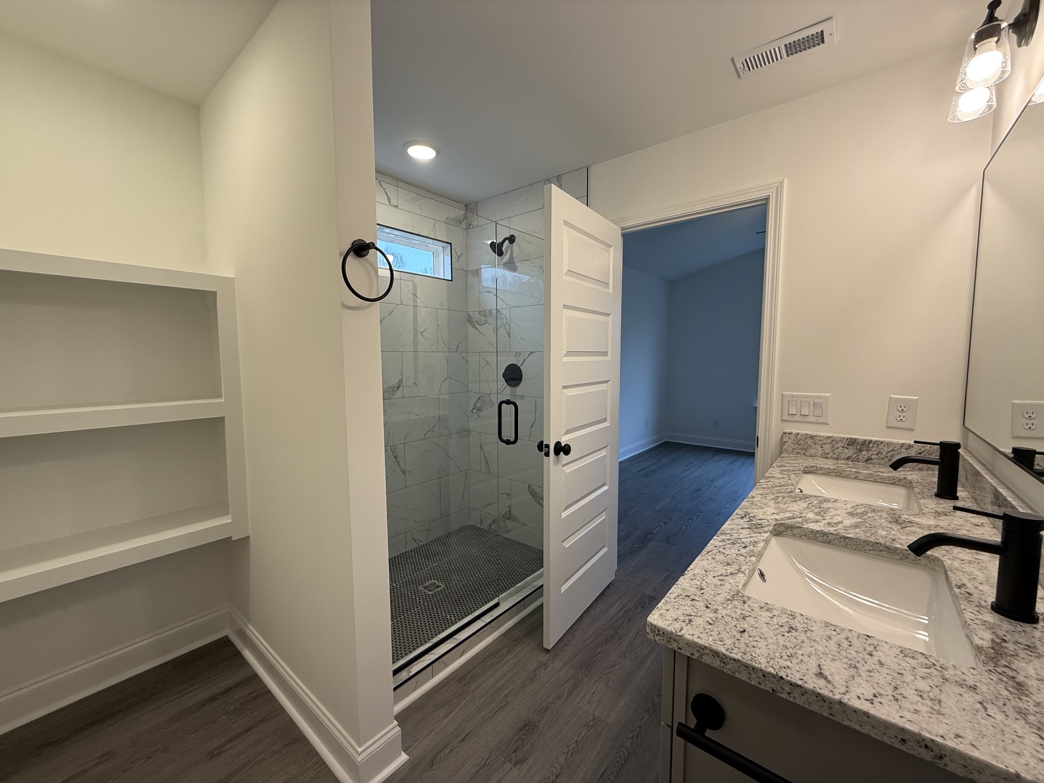 1135 Javier Drive Springfield, TN 37172 - Photo 5 of 11 a bathroom with a granite countertop sink a mirror and shower