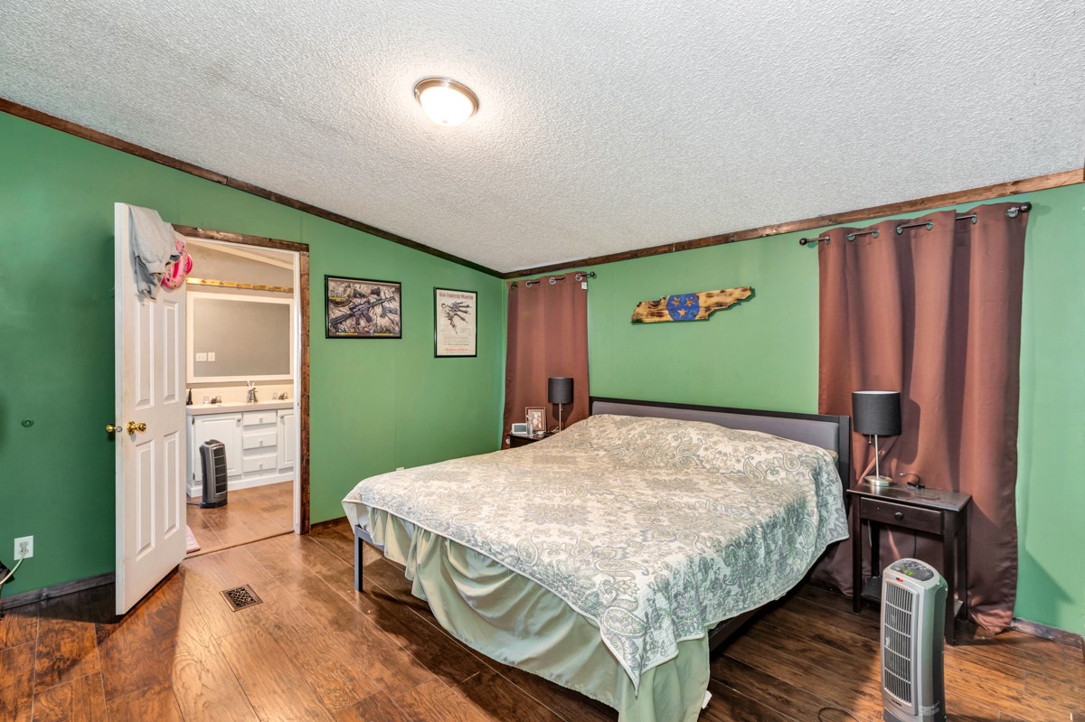 1919 Pleasant Hill Road Prospect, TN 38477 - Photo 13 of 24 a bed room with a bed and a television