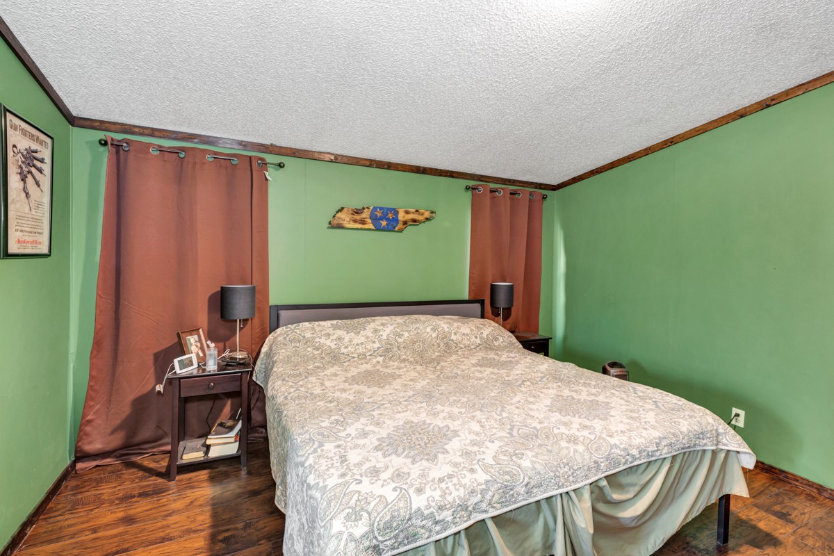 1919 Pleasant Hill Road Prospect, TN 38477 - Photo 14 of 24 a bedroom with a bed and wooden floor