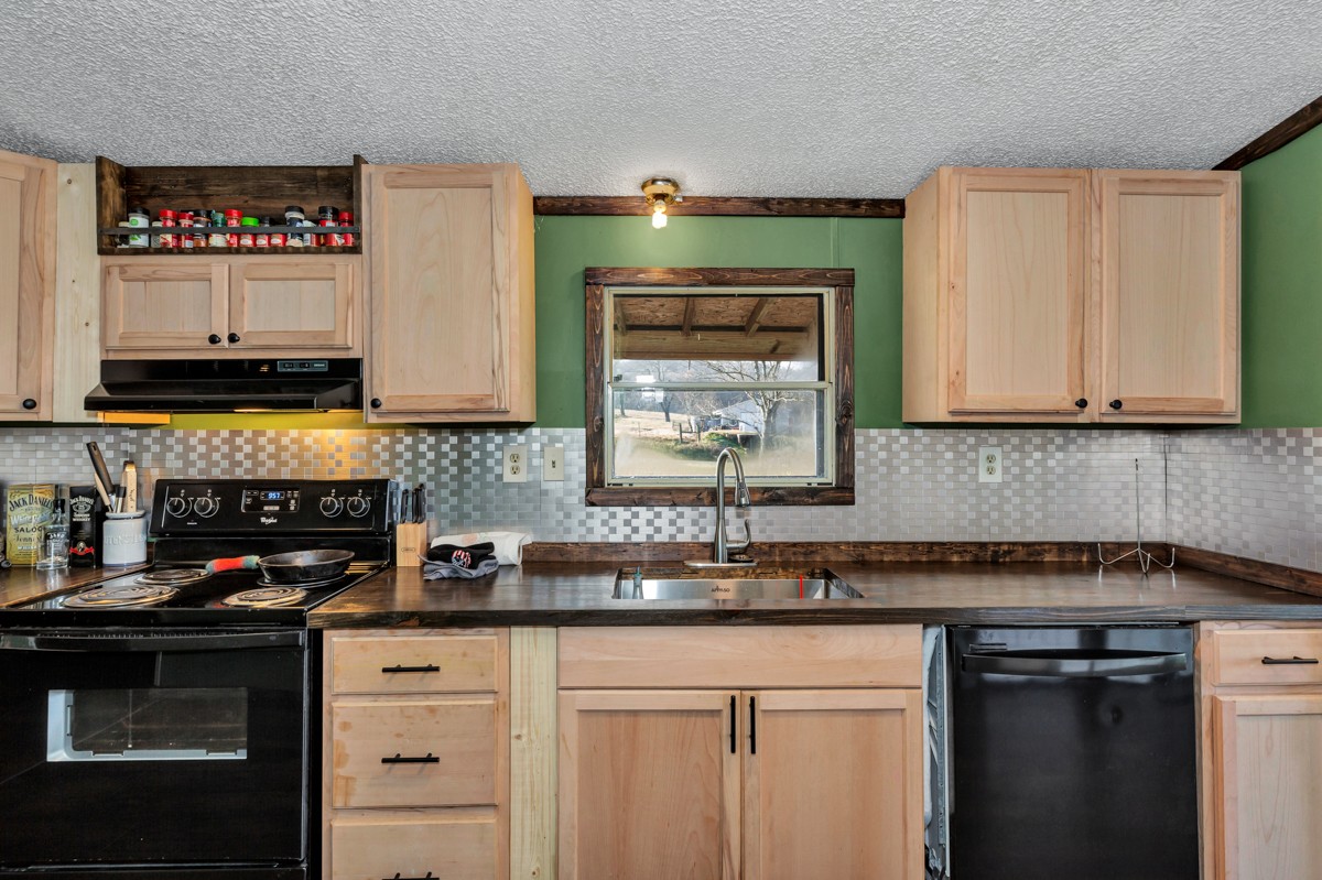 1919 Pleasant Hill Road Prospect, TN 38477 - Photo 9 of 24 a kitchen with stainless steel appliances granite countertop a sink stove and cabinets