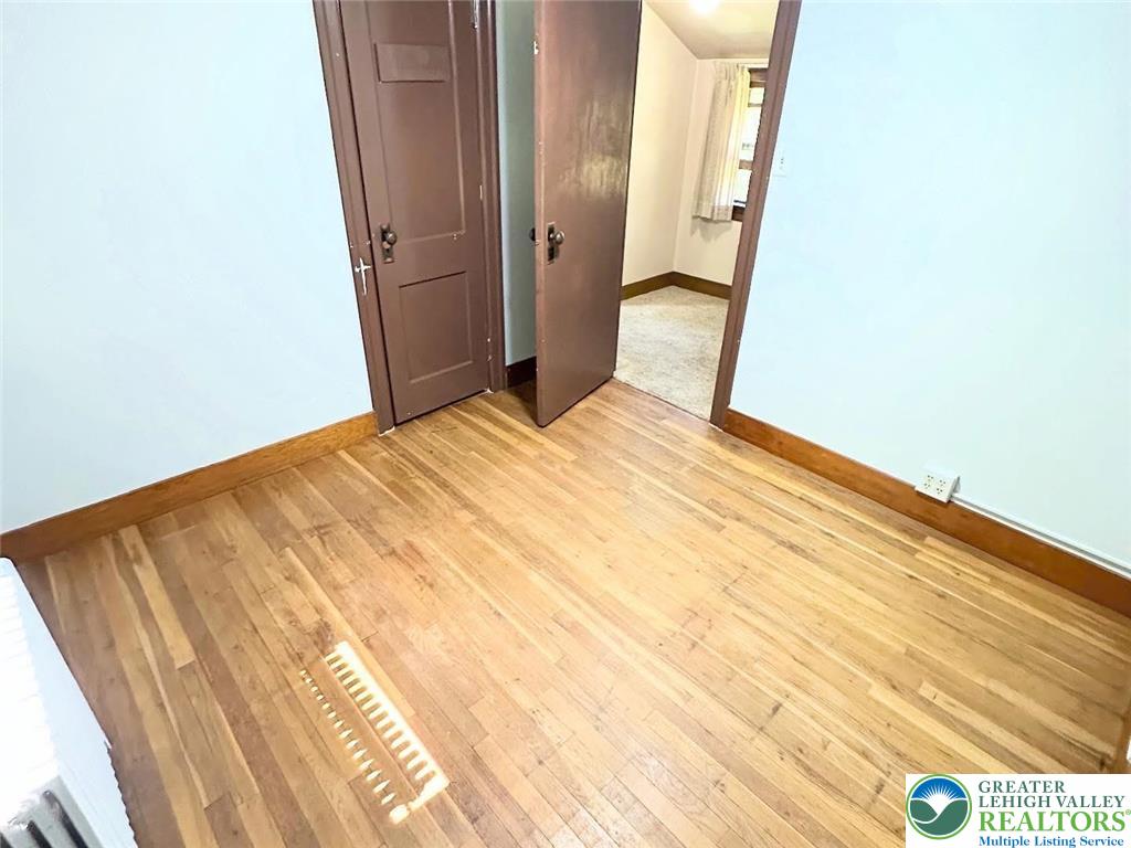 4024 South 2nd Street Emmaus, PA 18049 - Photo 18 of 19 a bedroom with a bed and wooden floor