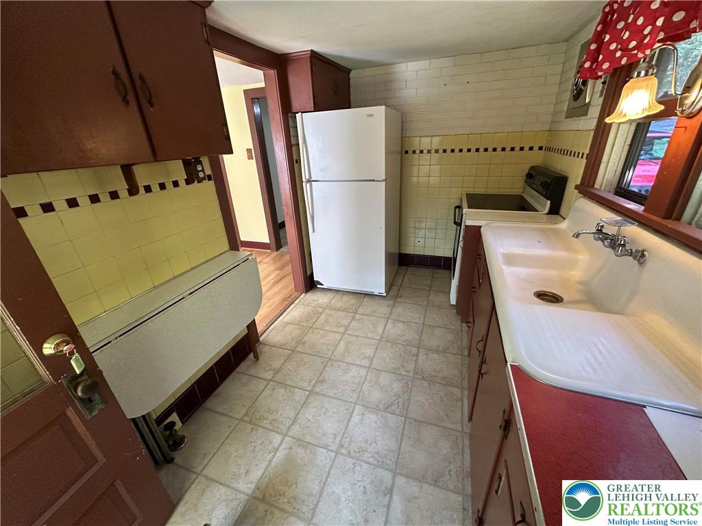 4024 South 2nd Street Emmaus, PA 18049 - Photo 7 of 19 a utility room with cabinets washer and dryer
